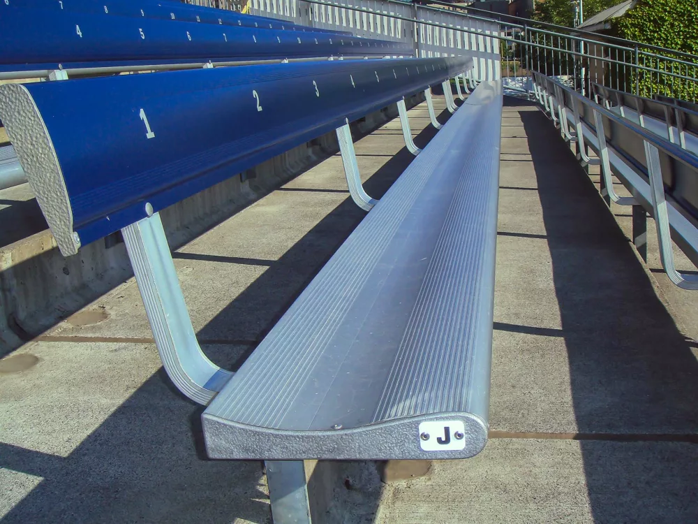 Aluminum bench seating, stadium seats with backs.