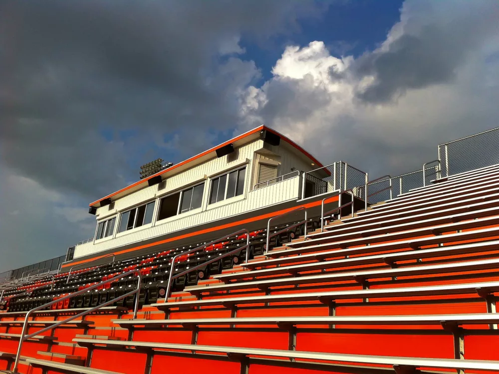 view of upper-half grandstand seating, with focus on the press box design.