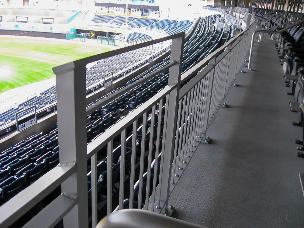 Picket railing system located at the top of bleacher seating systems.