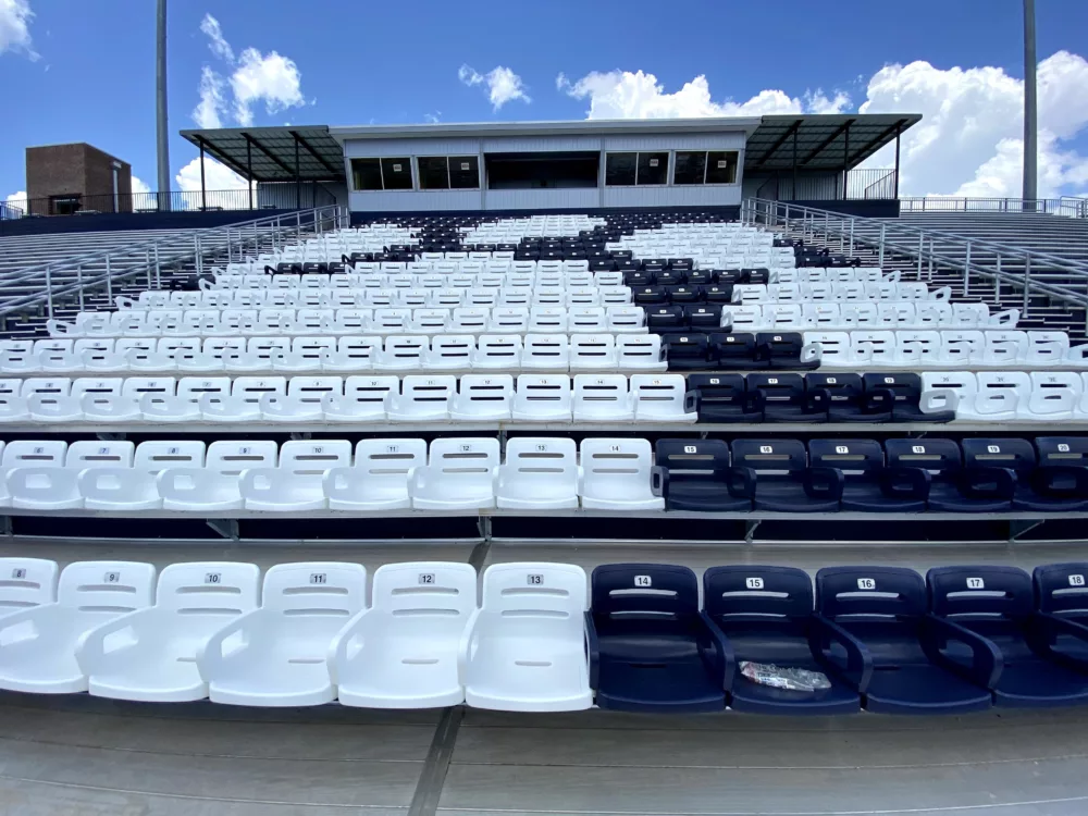 image showcasing blue and white chairs to create the image of a paw in the VIP seating section