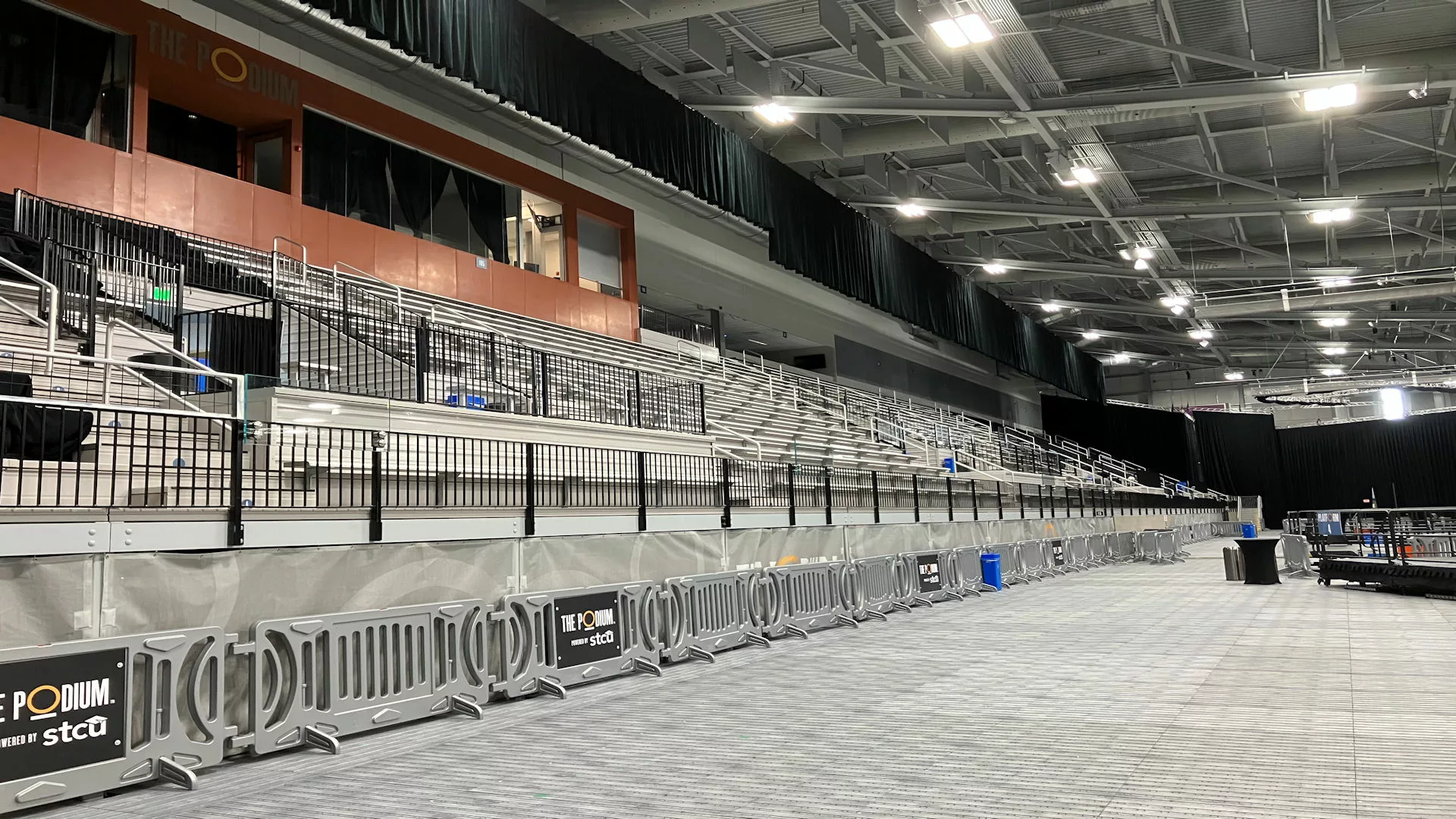 Image of indoor multi-purpose arena, I-Beam spectator seating with vertical picket railing