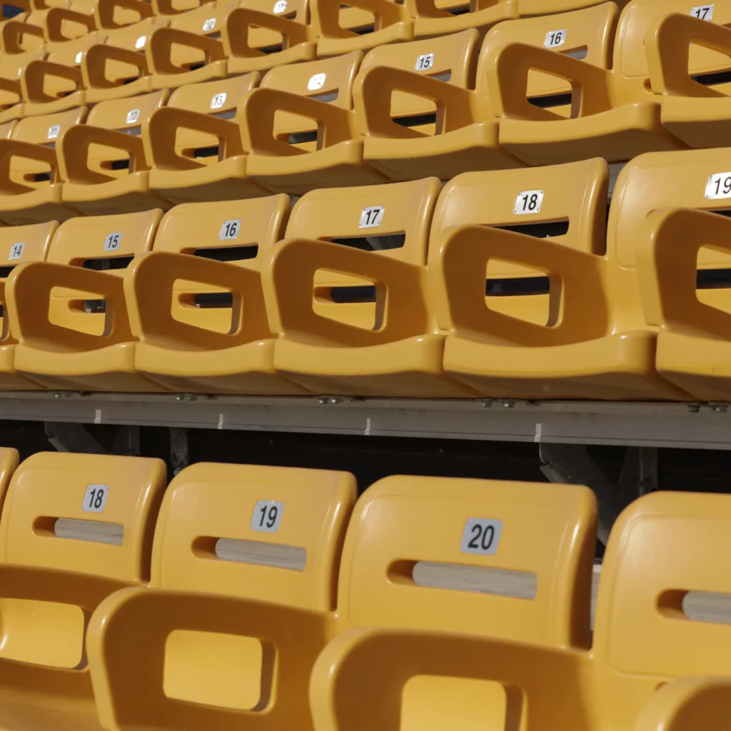 Stadium bleacher seats with backs.