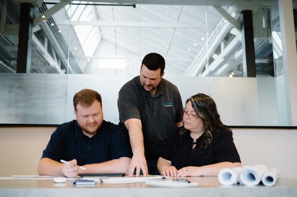 A team of Dant Clayton architects are looking over blueprints for an upcoming project.