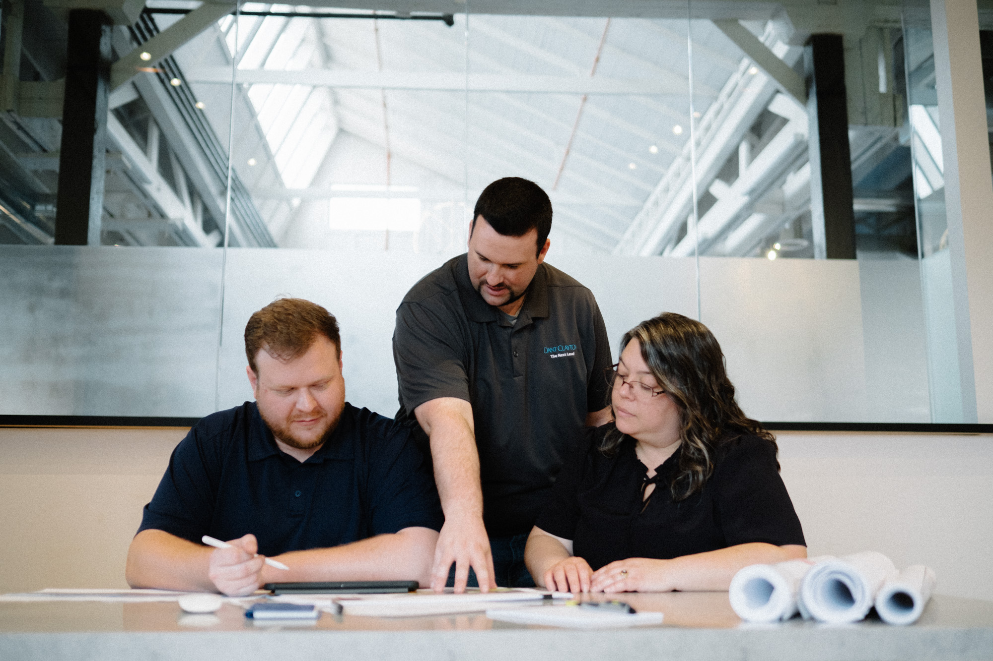 A team of Dant Clayton architects are looking over blueprints for an upcoming project.